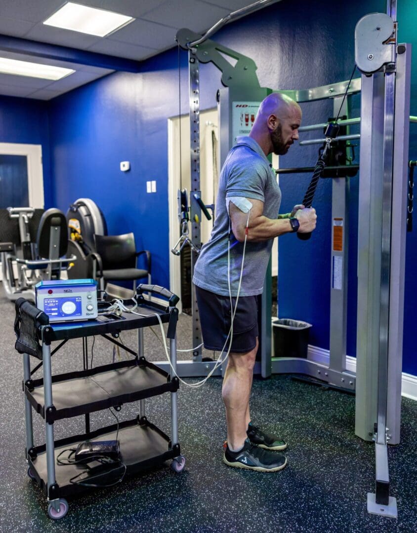 Man doing bicep curls with machine.