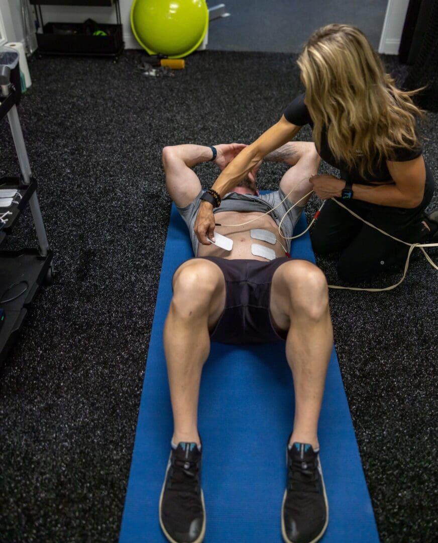 Man receives electrical muscle stimulation.