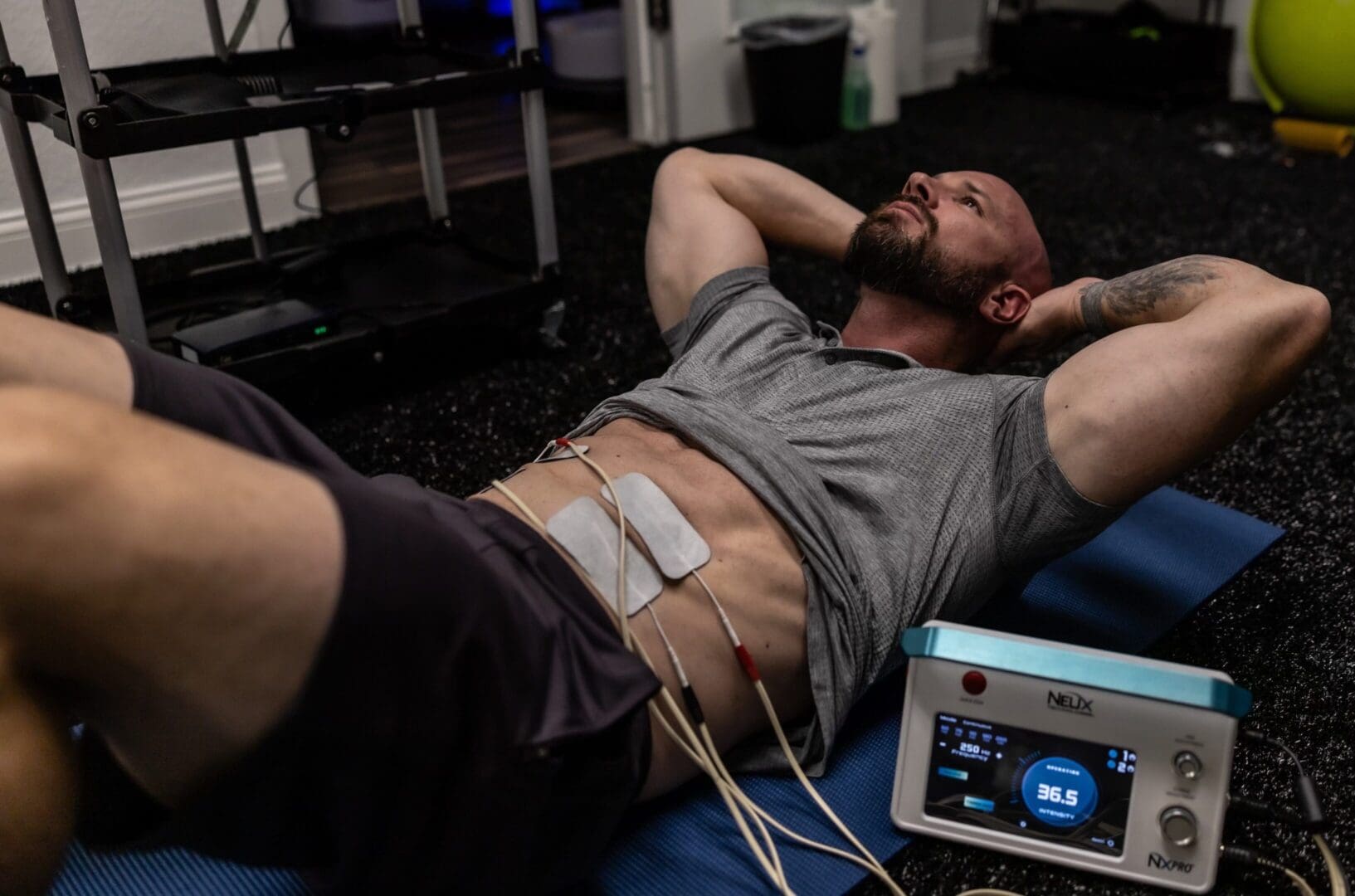 Man receiving electrical muscle stimulation.